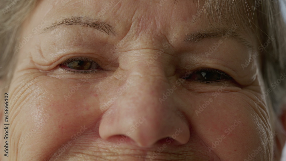 Senior woman closing eyes in contemplation in macro close-up. Eye_s detail of an older lady with wrinkles of wisdom in meditation. Person opening eyes and smiling Senior woman closing eyes in contemplation in macro close-up. Eye_s detail of an older lady with wrinkles of wisdom in meditation. Person opening eyes and smiling