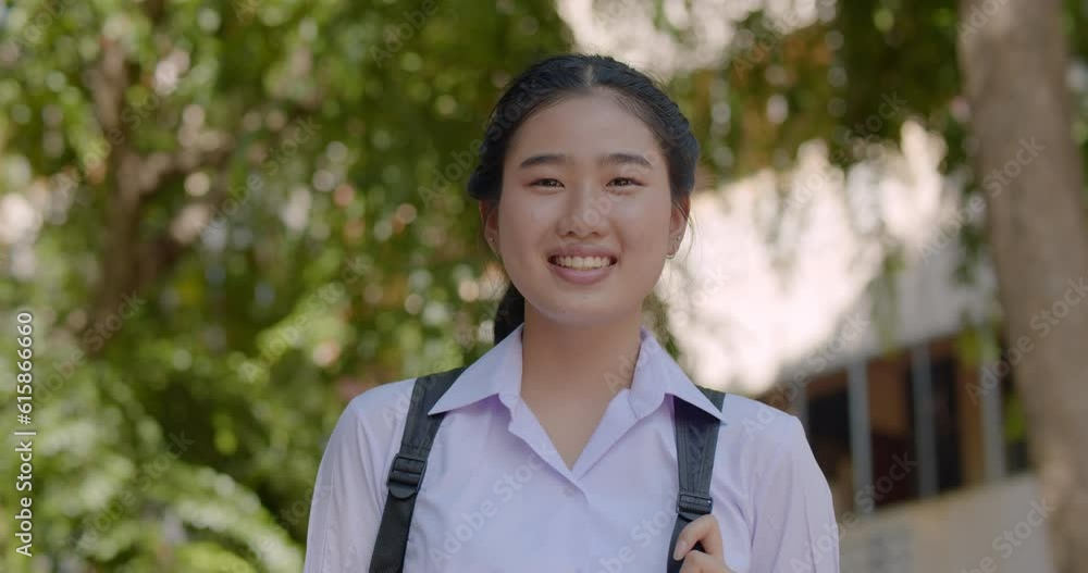 Slow motion : An Asian high school student girls in white uniform with school backpack going back to school in the morning, 