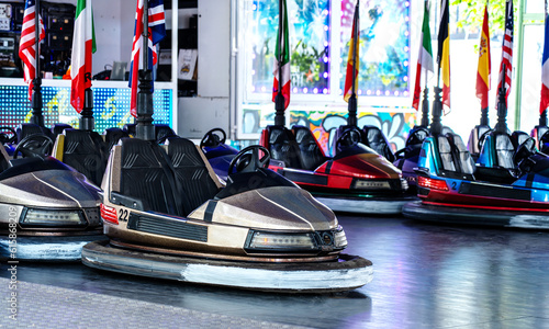 Colorful bumper cars stationary, flags, no people