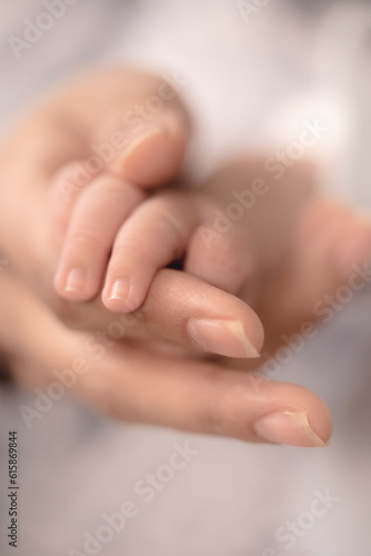 Baby fingers joins with her father's hand