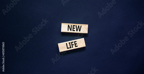 New life symbol. Concept words New life on wooden blocks on a beautiful black table black background. Business, support, motivation, psychological and new life concept. Copy space.
