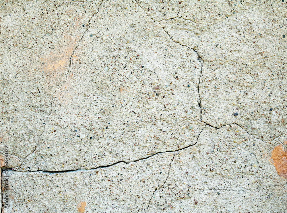 Fototapeta premium Old gray wall covered with cement plaster with deep cracks