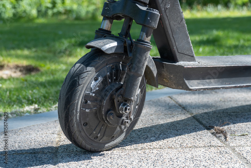 Details mechanism of used electric scooter closeup. Wheel, shock absorber public mobile transport. Equipment technology economical vehicle in contemporary urban. Device ecological dockless transport. photo