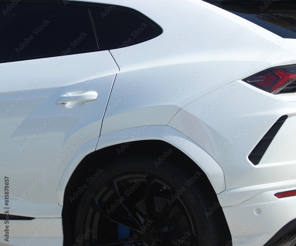 White SUV in motion closeup in Los Angeles, California. Sleek white sports car background. Car wallpaper closeup. White car. 