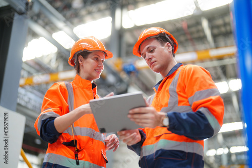 Two Technicians or Engineers Checking and maintaining Machine Equipment of train in station. photo