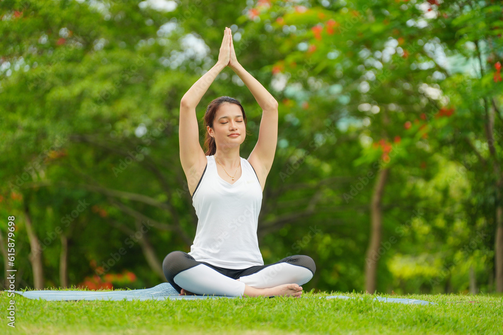 Pleasant millennial woman practice yoga outdoor in the morning during wellness retreat. Pleasant millennial woman practice yoga outdoor in the morning during wellness retreat.