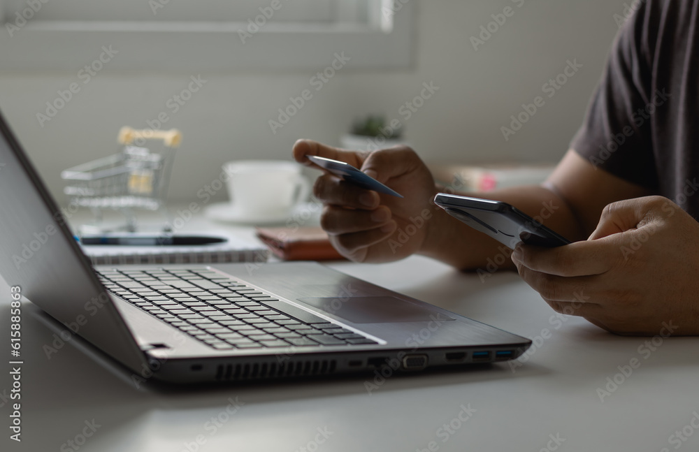 Online shopping concept. Customer makes a purchase on the Internet on a smartphone with a credit card, online payment, shopping online, e-commerce, internet banking, and spending money. Online shopping concept. Customer makes a purchase on the Internet on a smartphone with a credit card, online payment, shopping online, e-commerce, internet banking, and spending money.