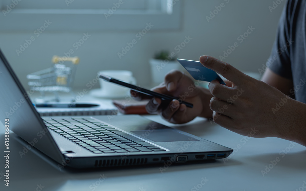Fototapeta premium Online shopping concept. Customer makes a purchase on the Internet on a smartphone with a credit card, online payment, shopping online, e-commerce, internet banking, and spending money.