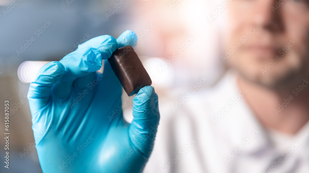 Worker control quality of sweets candy. Concept chocolate factory production line, food industry Worker control quality of sweets candy. Concept chocolate factory production line, food industry