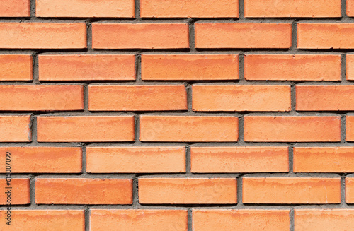 New red brick wall texture with cement straight seam lines. Flat straight bricks. Text space. Background closeup.