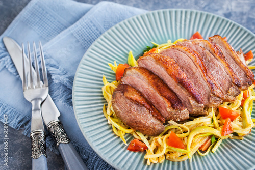 Roasted duck breast and zucchini noodles with tomatoes, healthy eating