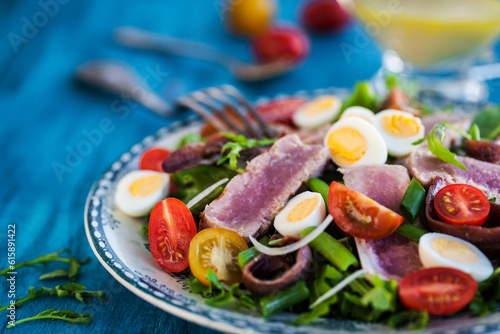 Tuna salad ( Nicoise) with tomatoes, boiled eggs, onion, anchovy and lettuce