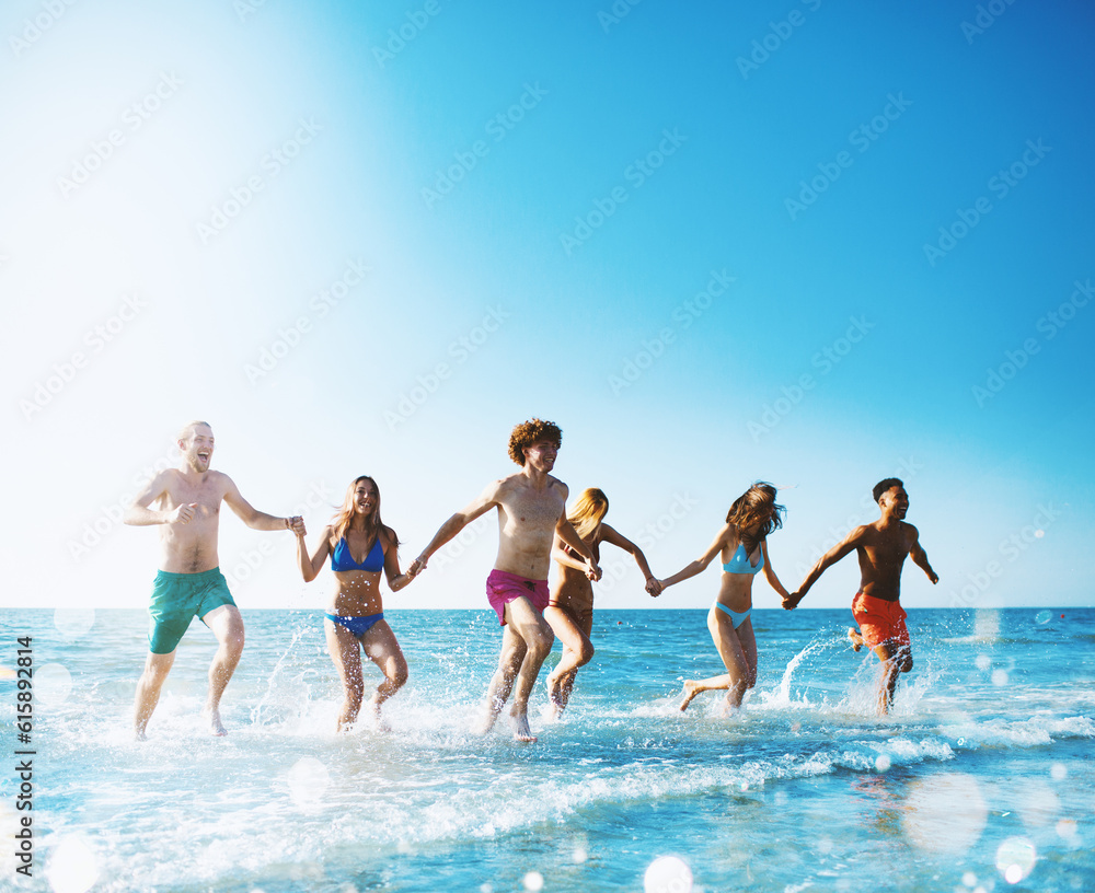 Group of friends run in the blue sea. Concept of summertime