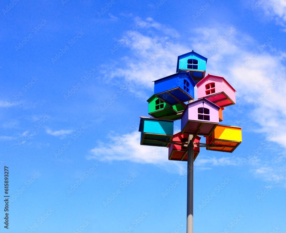 Colorful nesting boxes on blue sky background Colorful nesting boxes on blue sky background