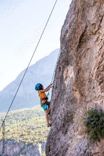 climber boy. the child trains in rock climbing.