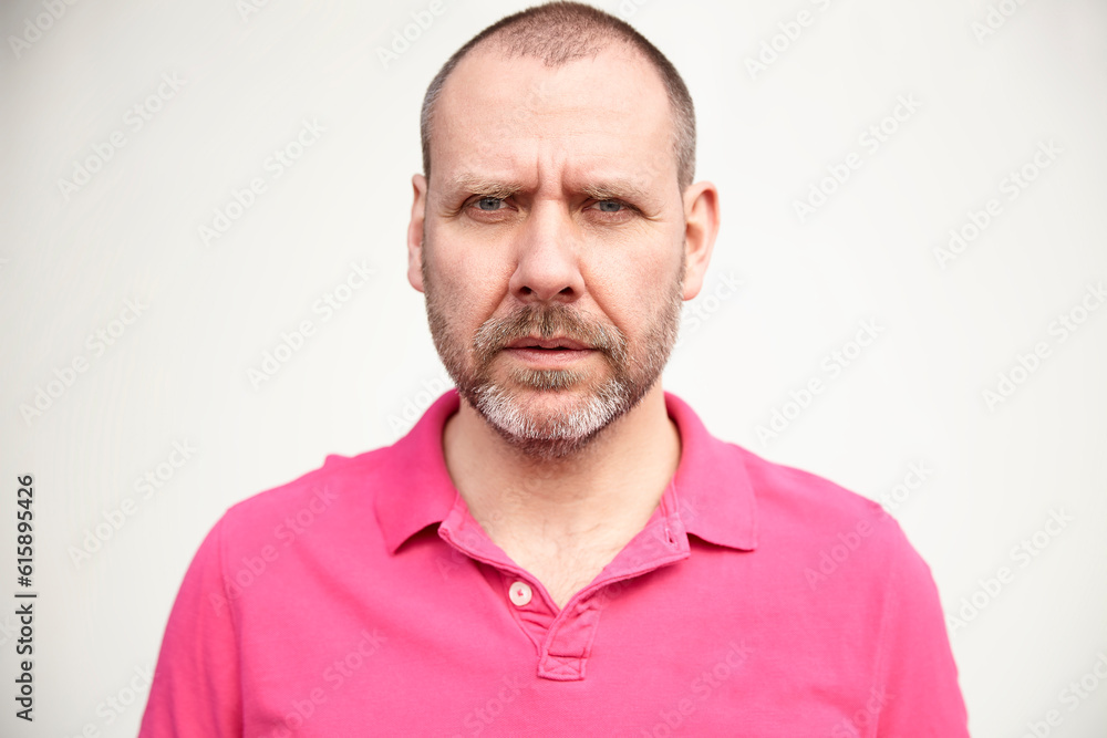 Portrait of casual mature man in pink t-shirt. Portrait of casual mature man in pink t-shirt.