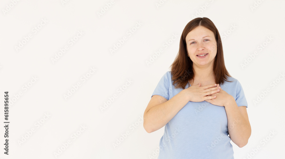 Close up of happy smiling woman say thank you, holding hands on heart grateful, express gratitude, standing against white background. Close up of happy smiling woman say thank you, holding hands on heart grateful, express gratitude, standing against white background.