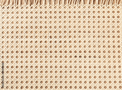 Embossed background of large-weave rattan stems close-up photo
