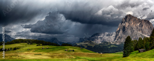 storm over the mountains Dolomiti in the summer season with green meadow illuminated of the Sun © Designpics
