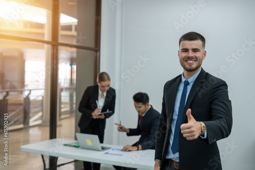 portrait of a smiling business man and the business team 