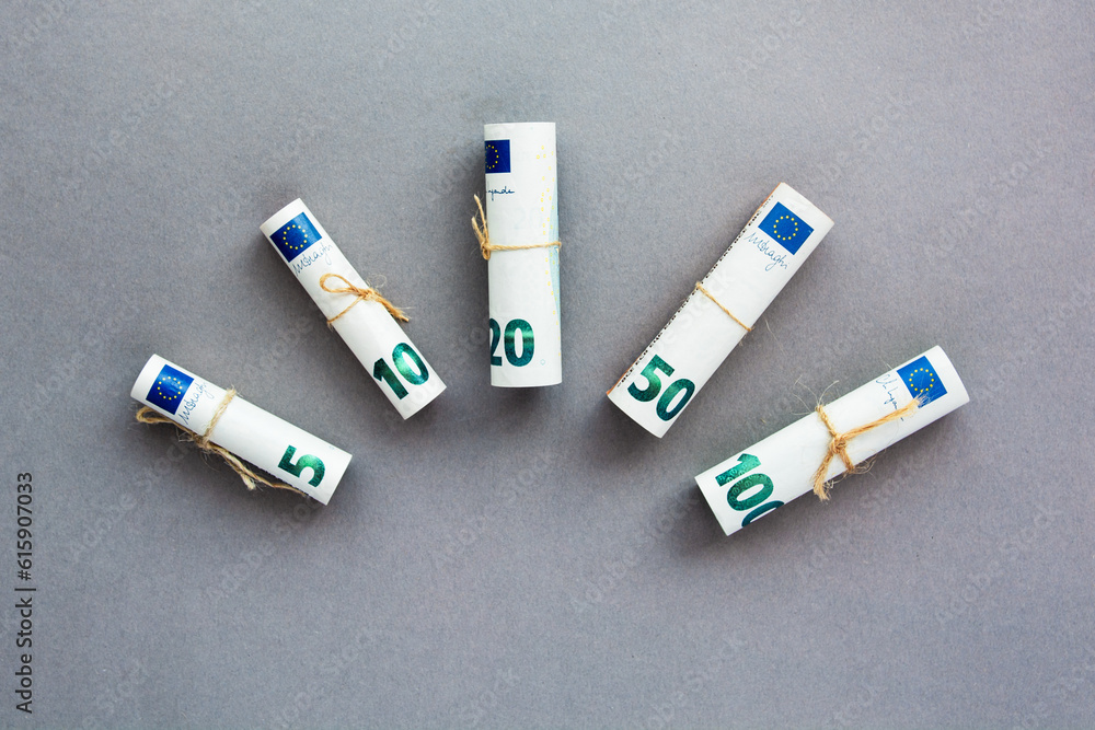 European currency twisted into a tube in ascending order, Euro money cash banknotes from 5 to 100 nominal. European currency twisted into a tube in ascending order, Euro money cash banknotes from 5 to 100 nominal.