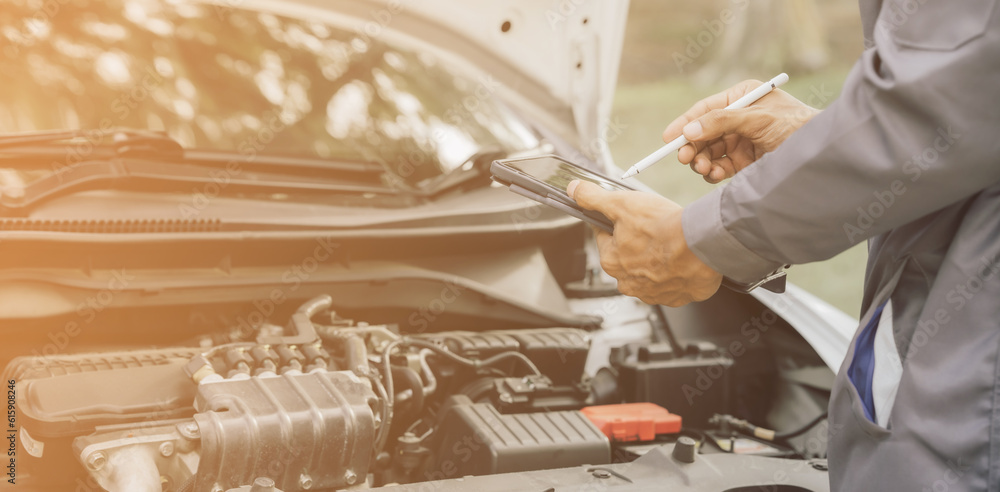 Obraz premium Automobile mechanic repairman hands repairing a car engine automotive workshop with a wrench, car service and maintenance,Repair service.