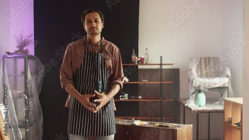Wallpaper Mural Confident adult male Caucasian furniture repairman in a special protective apron in a working workshop posing against the background. Individual entrepreneurship Torontodigital.ca