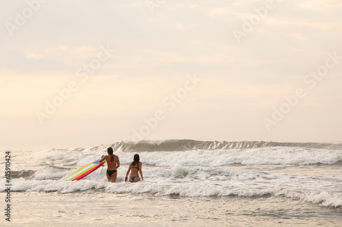 Couple surfer at the beach enjoying your vacations