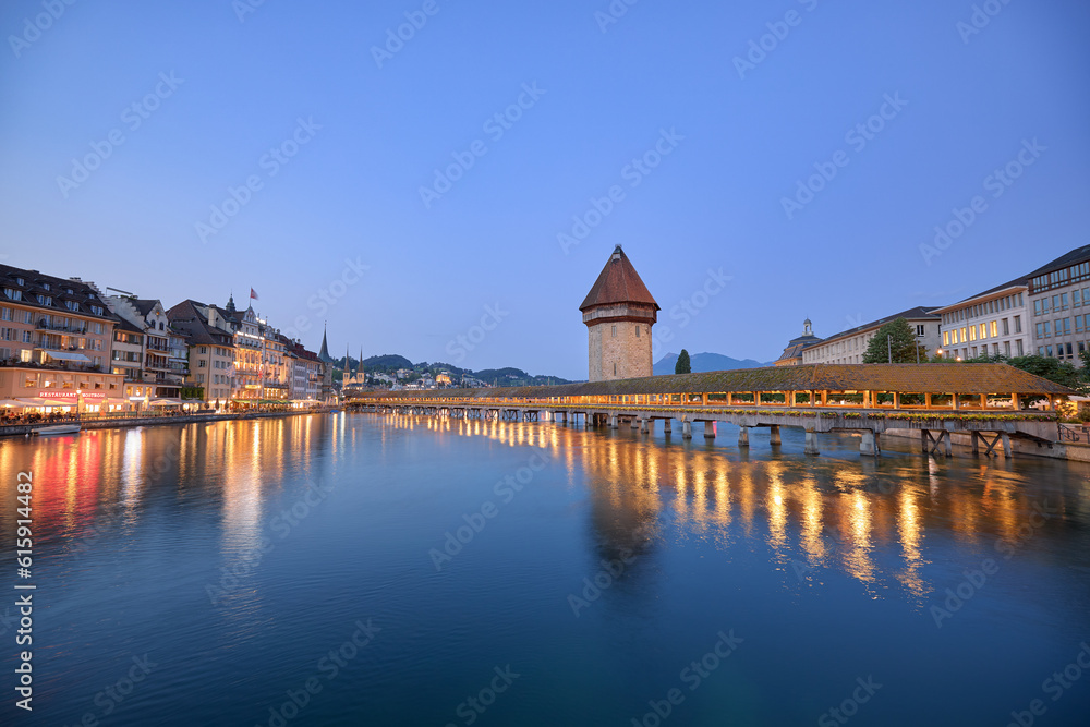 View of the chapel bridge at sunset in Lucerne, Switzerland.
