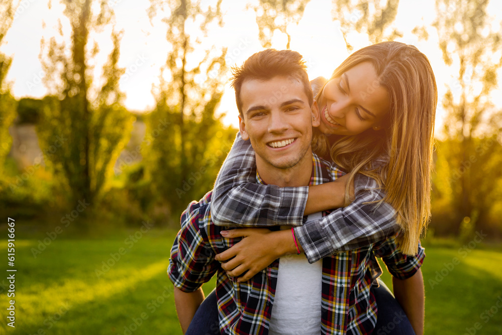Fototapeta premium Portrait of a happy young couple in the nature hugged together