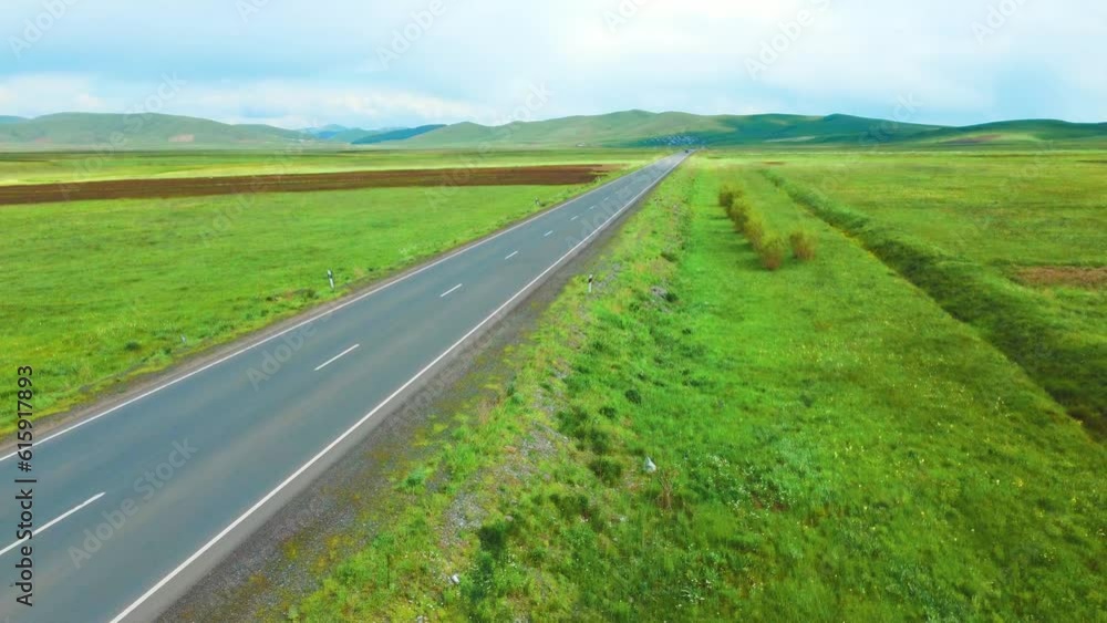 White truck drives on asphalt road along green fields. Aerial view. Bird's-eye view of landscape. Delivery of goods . Concept of delivery and transportation of goods White truck drives on asphalt road along green fields. Aerial view. Bird's-eye view of landscape. Delivery of goods . Concept of delivery and transportation of goods