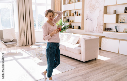 Wallpaper Mural Content woman browsing smartphone while standing in room Torontodigital.ca