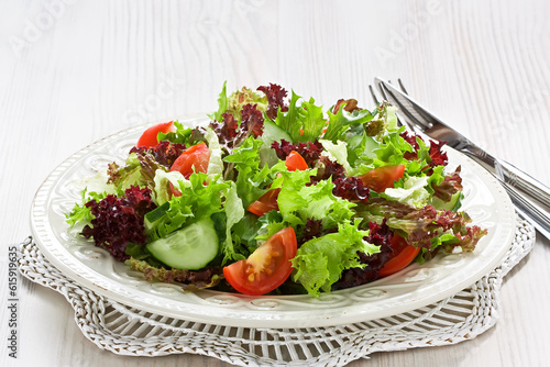 Fresh salad with green  red lettuce  tomato and cucumber