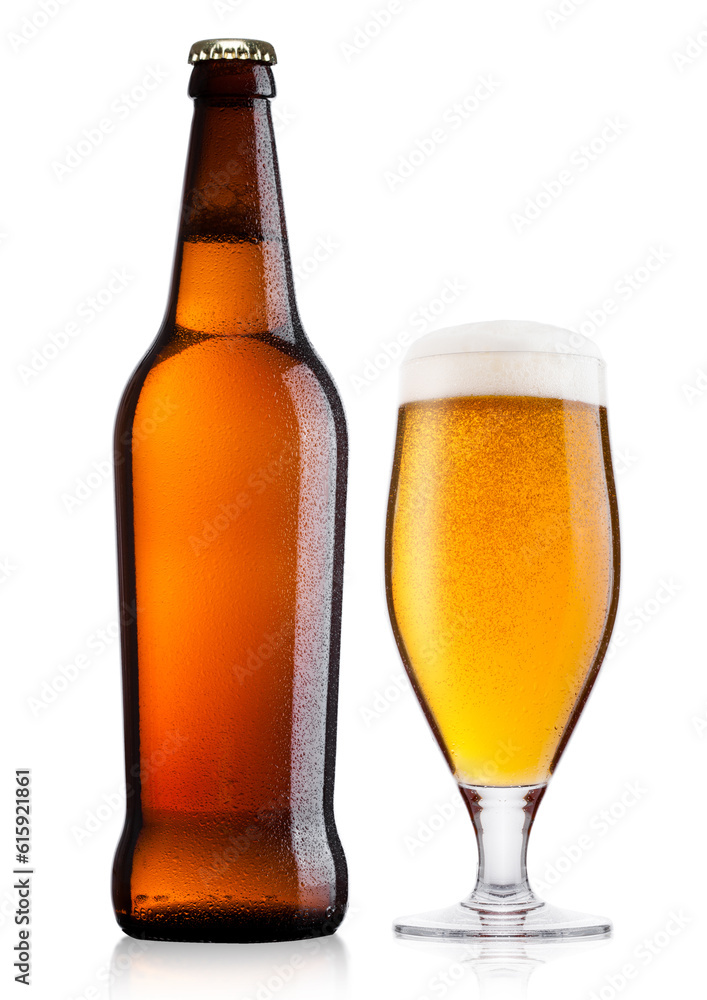 Cold bottle and glass of lager beer with foam and dew isolated on white background