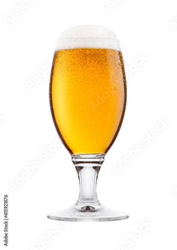Cold glass of lager beer with foam and dew isolated on white background