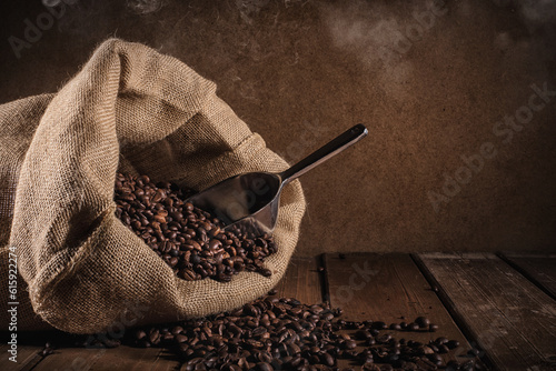 Coffee beans with jute bag and bailer on grunge background