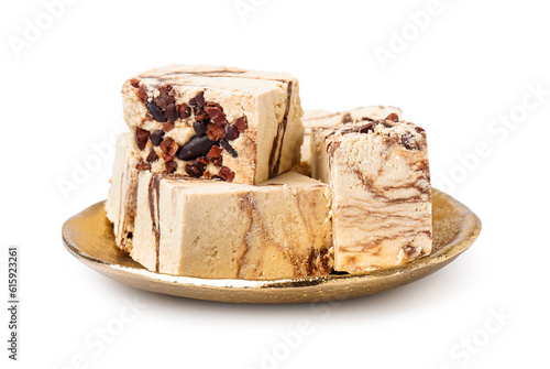 Plate with pieces of tasty marble halva on white background photo