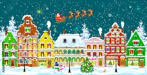 City street in the winter night. Christmas Eve. Winter holiday. Houses in winter night. Snow on a city street. Decoration houses on winter holidays. © Designpics