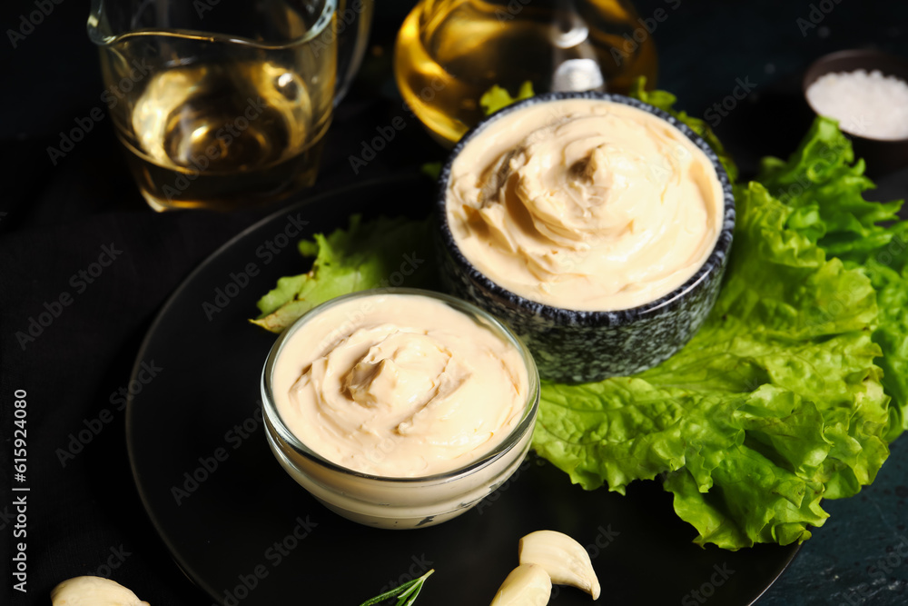 Bowls of tasty cream cheese on dark background Bowls of tasty cream cheese on dark background