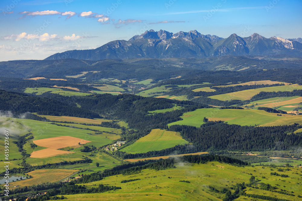 Spisz region: Green fields on the hills in front of Tatra mountains