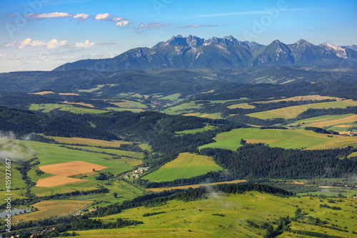 Spisz region: Green fields on the hills in front of Tatra mountains