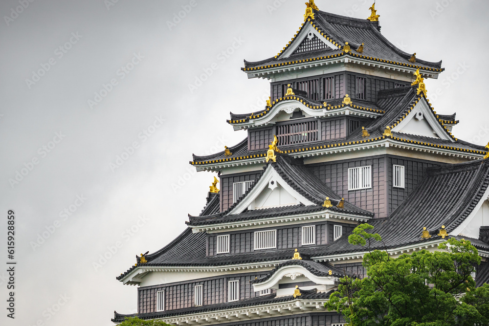 Fototapeta premium Facade of Okayama Castle against white sky, close-up of Japanese castle with text space