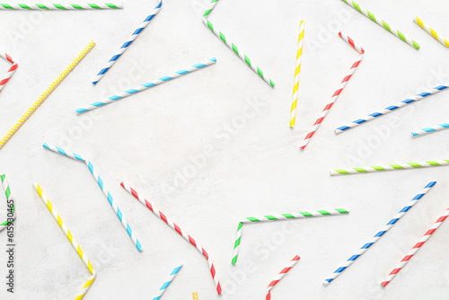 Frame made of different paper drinking straws on white background