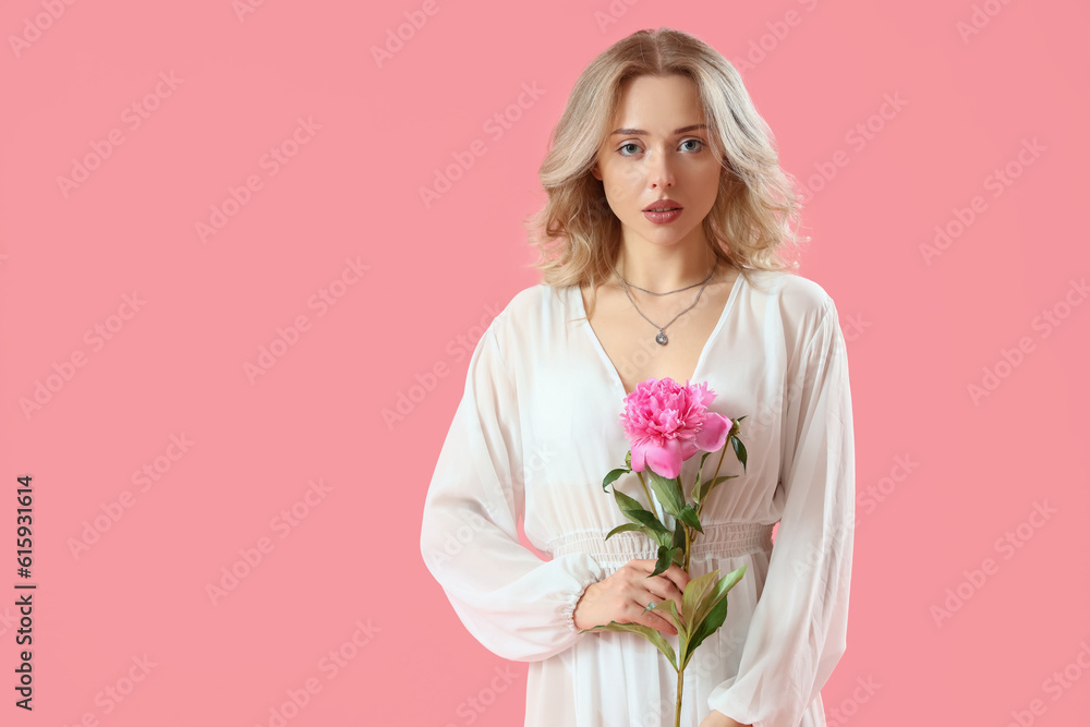 Young woman with beautiful peony flower on pink background Young woman with beautiful peony flower on pink background