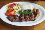 Kebab, traditional turkish meat food with salad on a plate 