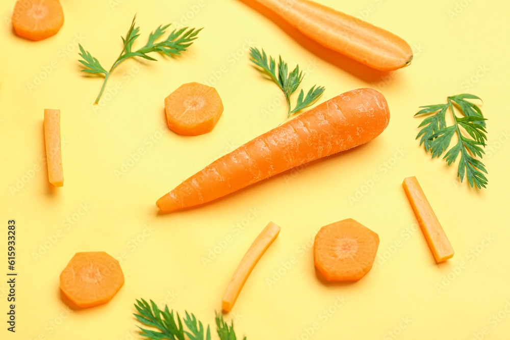 Fresh carrots and slices on yellow background Fresh carrots and slices on yellow background