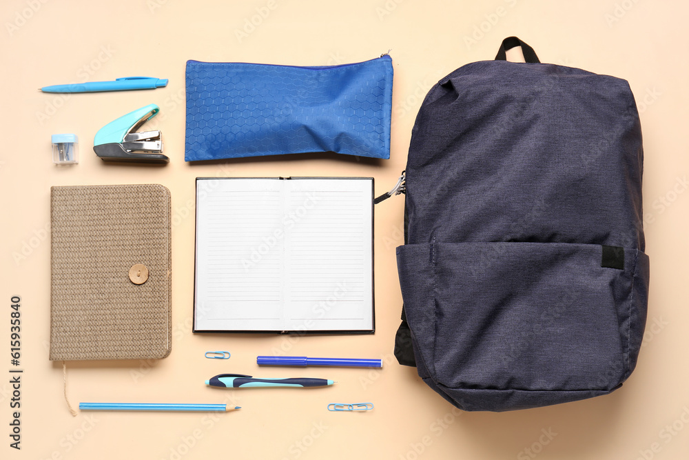 Notebooks with backpack, pencil case and different stationery on pale orange background Notebooks with backpack, pencil case and different stationery on pale orange background