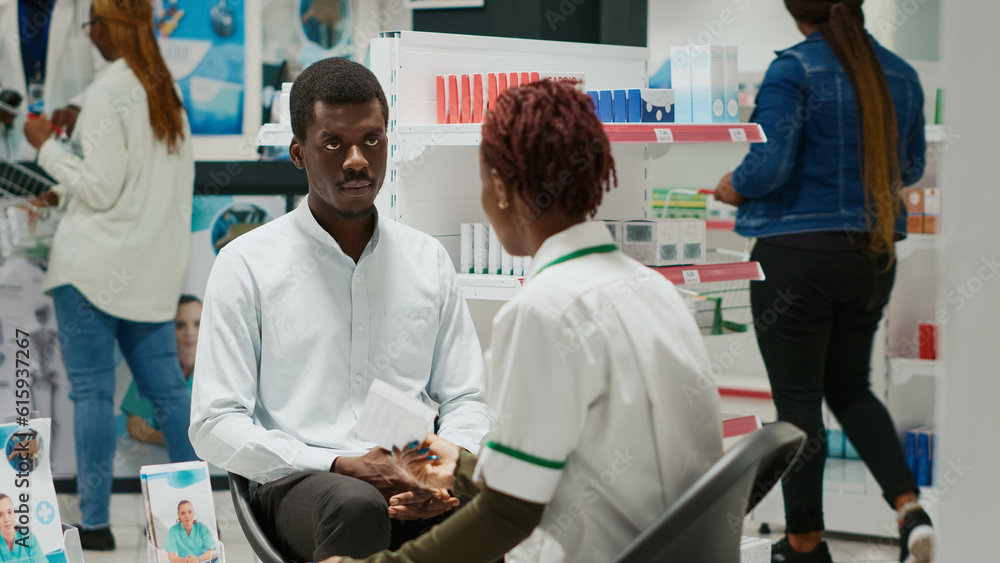 Obraz premium African american people talking about medicaments in drugstore, talking about heathcare with vitamins and drugs. Pharmacy giving box of supplements and pills to client in health center.
