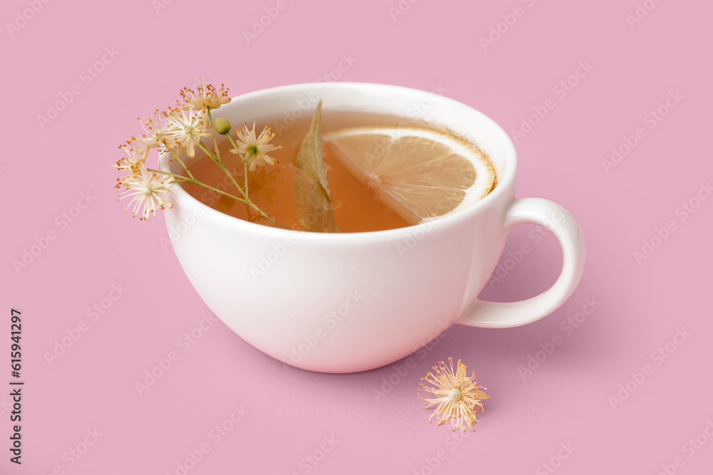 Cup of linden tea with lemon on pink background Cup of linden tea with lemon on pink background