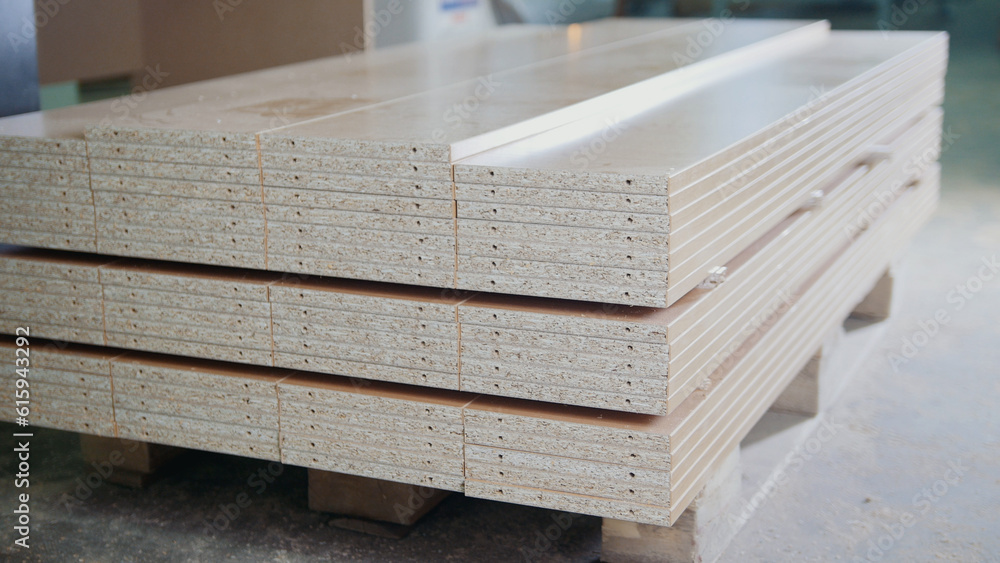 Stack of wood particleboard panels on the warehouse or factory, industrial concept Stack of wood particleboard panels on the warehouse or factory, industrial concept